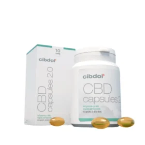 A bottle and box of Cibdol 10% CBD softgels capsules, with three capsules visible in the foreground.