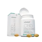 A bottle of Cibdol 5% CBD softgel capsules (60 pieces – 8.3 mg) is open next to its box, with three capsules visible in front.