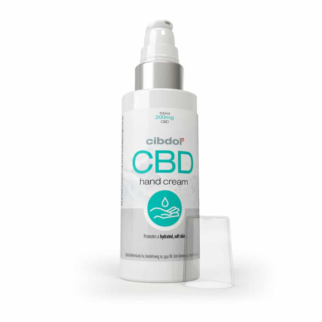 a bottle of cbd hand cream next to a container.