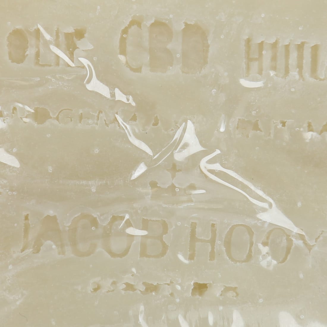 a close up of a piece of Jacob Hooy CBD Soap with writing on it.