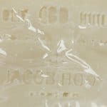 a close up of a piece of Jacob Hooy CBD Soap with writing on it.